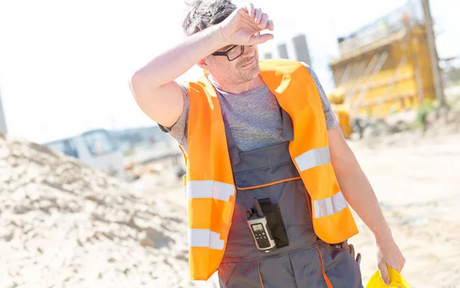 Construction worker wiping away sweat.