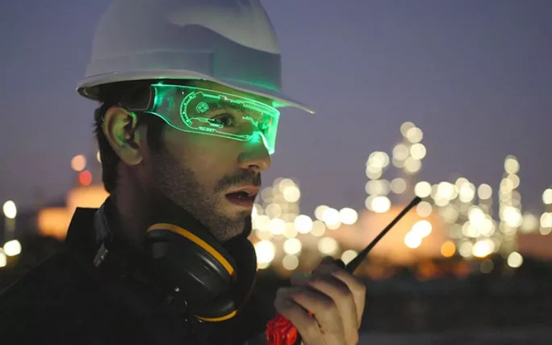 Worker wearing safety glasses that glow with lights.