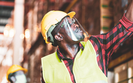 Warehouse worker wears a faceshield.