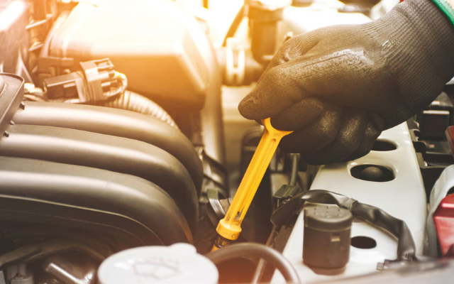 Mechanic working on vehicle wears gloves coated to protect from oils and spills. 