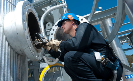 Worker conducting purge testing in a confined space.