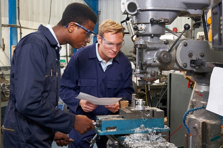 Machinists drilling while wearing PPE.