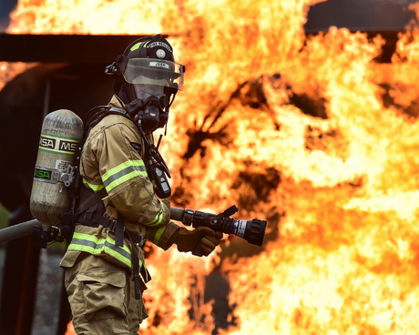 Firefighter working to put out flames.