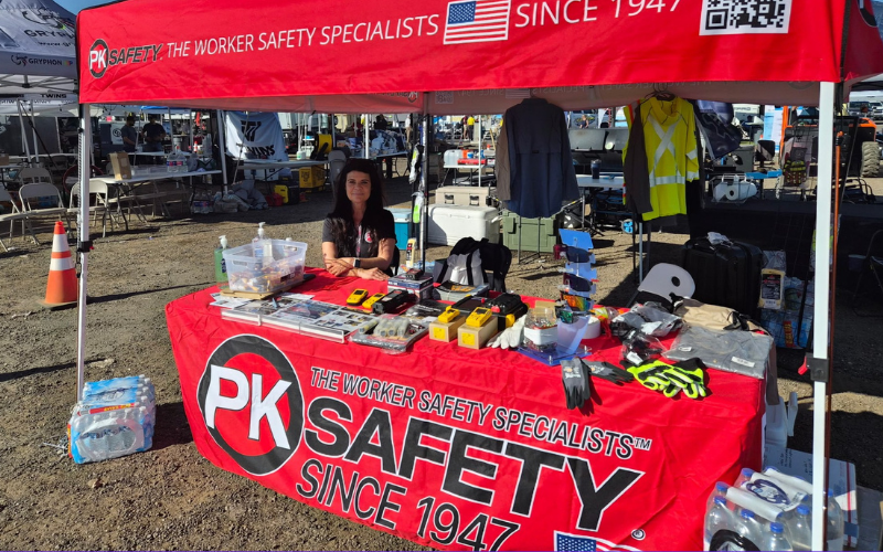 PK Safety worker sits at booth with at West Texas Oil & Gas Convention.