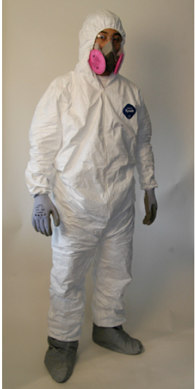Man wearing hazmat suit, booties, gloves and full-face respirator with white background.