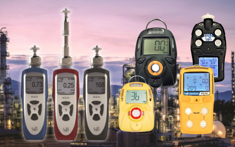A variety of gas detectors displayed against a backdrop of an industrial plant at dusk. The devices show digital readings, indicating measurement functionalities.