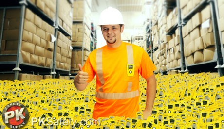 Many yellow gas monitors surrounding a worker waist-deep in a warehouse giving a thumbs up.