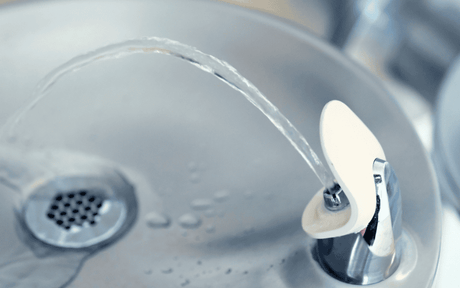 Close up shot of a drinking fountain with water coming out