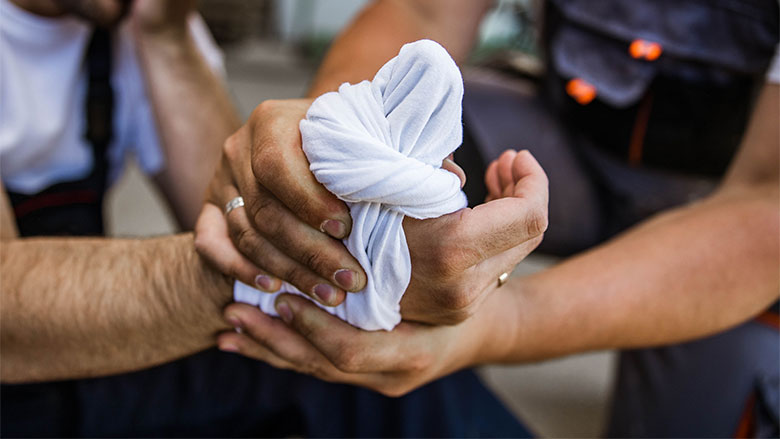 Worker's thumb wrapped up after suffering a hand injury.