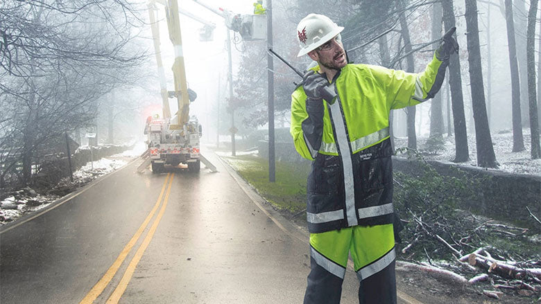 Road worker wearing FR rainwear during drizzly weather.