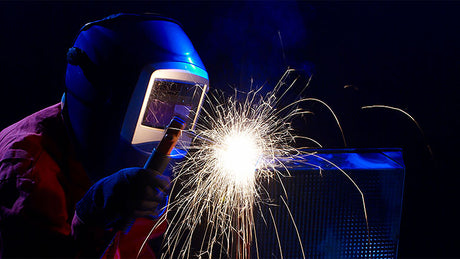 Welder working as sparks are flying.