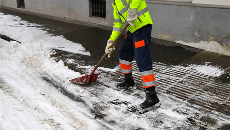 Worker shoveling snow.