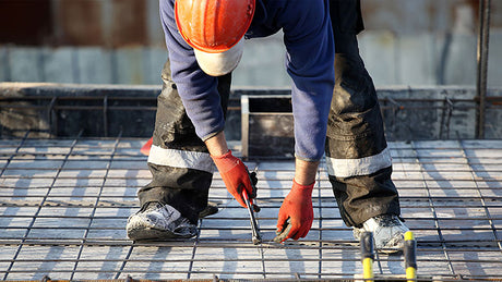 Construction worker wearing safety gloves.