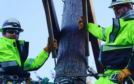 Two utility workers in hi vis workwear and PPE.