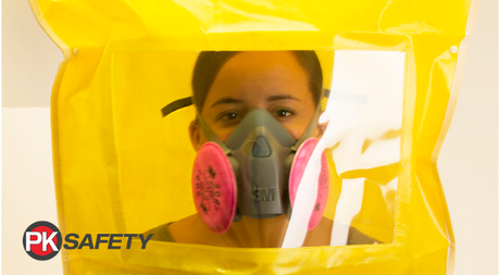 Woman wearing a half-mask respirator with yellow fit test bag covering head.