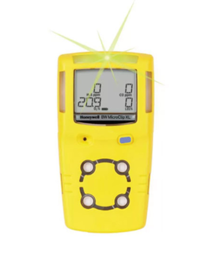Yellow portable gas detector with a digital screen displaying numeric readings. It has buttons below the screen and is labeled "GASALERT MICROCLIP XL." The device is designed for detecting hazardous gases.