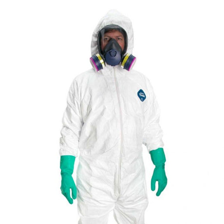 Man wears hazmat suit with full-face respirator and green gloves on white background.