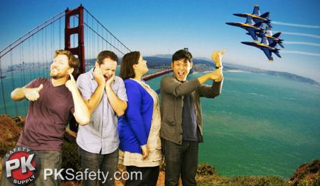 Group of people watching Blue Angels fly near Golden Gate Bridge.