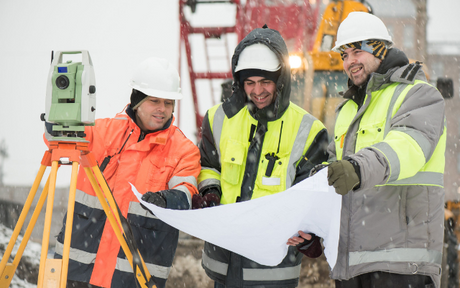 Workers bundled up in winter workwear.