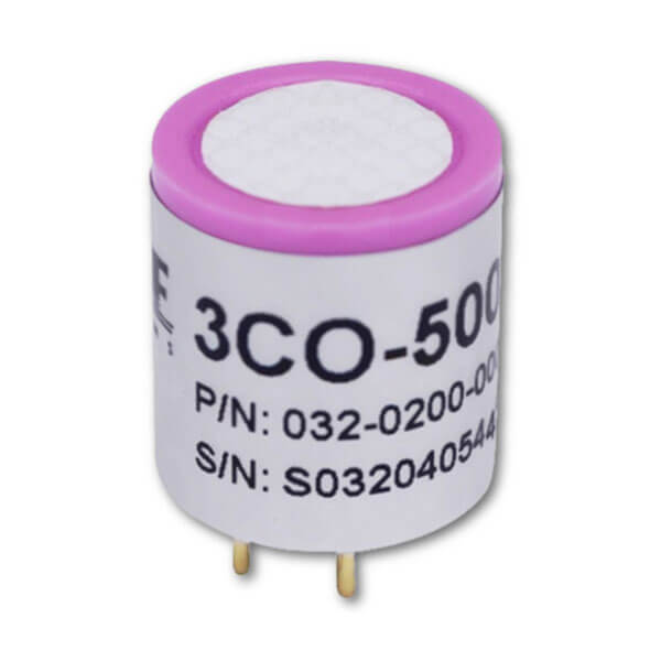 The RAE Systems CO Replacement Sensor 032-0200-003 is a compact cylindrical sensor with a white body, pink top, and gold pins. Compatible with QRAE 3 monitors, it features “3CO-500” and part/serial numbers printed on the side.