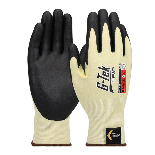 A pair of PIP Paradox Kevlar Gloves with black foam nitrile grip on palms and fingers, featuring cut protection and PIP branding. Heat resistant work gloves shown upright to display both front and back. Model: 09-K3511, 12 pairs.