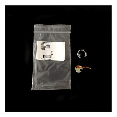 On a black background, there is a transparent plastic bag adorned with a barcode and printed details next to a small orange and white bird-like figure, an O2 sensor, and a silver ring. This setup includes the BW Honeywell's BW Micro Clip XT/XL Replacement Flex PCB, model MC2-FPCB1.