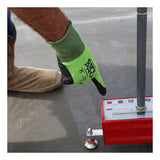 A person wearing MCR Safety CutPro HyperMax MicroFoam Nitrile Gloves 92785NF presses a button on a red electronic measuring device on concrete. Their boot and part of their leg are also visible.