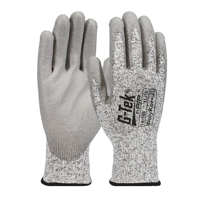The PIP G-Tek PolyKor Blended Gloves 16-530 are grey, with polyurethane-coated, textured palms to enhance grip. This product by PIP - Protective Industrial Products provides cut resistance and wrist coverage, making it suitable for industrial or protective use.