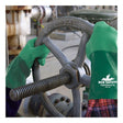 Someone wearing MCR Safety Neomax Neoprene Glove 6912 (12 pairs) is turning an industrial valve wheel marked "OPEN" and "CLOSE" in a factory or material handling setting.