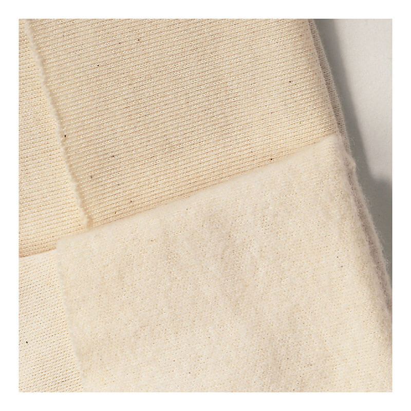 Close-up of two overlapping fabrics from the MCR Safety Neomax Neoprene Glove 6912—smooth, dense neoprene and a soft, fuzzy lining—showcasing textures ideal for safety gloves by MCR Safety, especially for material handling tasks.