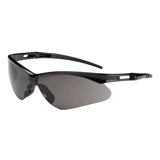 Introducing the PIP Bouton Anser Gray Safety Glasses: These stylish wrap-around glasses feature a sleek design with gray tinted lenses and a lightweight plastic frame. The aerodynamic curves and small openings near the temples offer impact protection while providing superior UVB light absorption for enhanced safety. Available in boxes of 12, these glasses combine functionality and style from the trusted PIP brand.