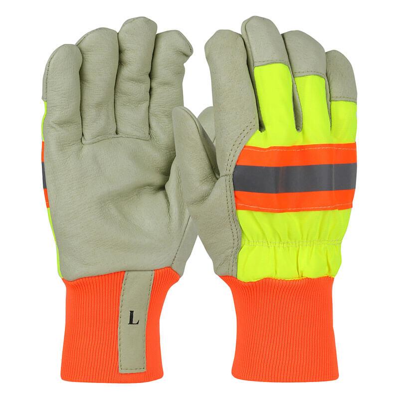 The PIP Premium Pigskin Leather Palm Gloves with Nylon Hi-Vis Back, model HVY1555, are ideal for cold weather applications. They feature gray pigskin leather palms and fluorescent yellow backs with an orange and gray reflective stripe. The gloves also have orange cuffs, with the size "L" marked on one glove. These gloves come in a set of 12 pairs from the brand PIP - Protective Industrial Products.