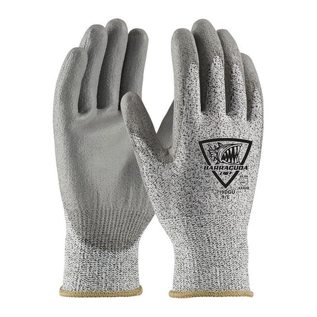 A pair of gray, textured PIP Barracuda Polykor Gloves features the PIP branding in black on the back. Designed for excellent cut resistance and secure handling, these gloves have a polyurethane coated flat grip and a reinforced cuff edge for enhanced protection.