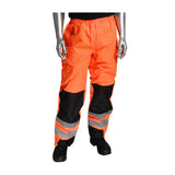 A mannequin displays the PIP ANSI 107 Class E Ripstop Reinforced Overpant 318-1771 workwear, characterized by its vivid orange color and reflective gray and black patches. The overpants feature an elastic waistband and two front pockets, paired with sleek black shoes for a complete look.