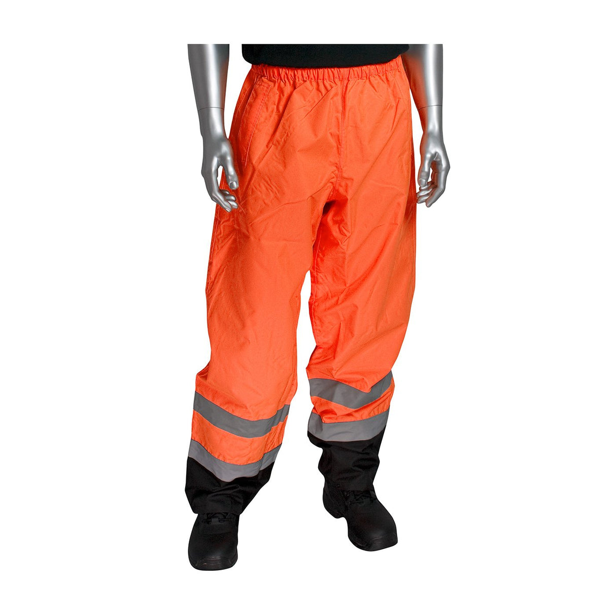 The mannequin showcases the PIP Class E Value Black Trim Over Pant 318-1757, bright orange safety pants crafted from waterproof polyester with reflective silver stripes near the ankles. These pants feature an elastic waistband and are paired with black boots. The upper body of the mannequin is not visible.