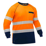 The PIP Bisley Long Sleeve Shirt w/Navy Bottom 313M6118T by Protective Industrial Products offers safety in low-light conditions with its orange and navy blue color scheme and reflective tape across the chest and arms. This design includes a small chest pocket, providing practicality along with enhanced visibility.