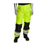 A mannequin showcases the PIP ANSI 107 Class E Ripstop Reinforced Overpant 318-1771 from PIP - Protective Industrial Products. This high visibility rainwear features neon yellow and black waterproof pants with reflective strips, complete with an elastic waistband and pockets for added functionality. The look is completed with black shoes, ensuring both safety and style on the job site.