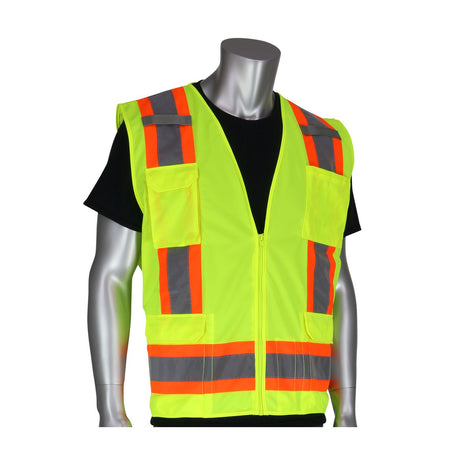 A mannequin displays a hi-visibility apparel piece, showcasing the PIP ANSI Class 2 Two-Tone Six-Pocket Surveyor's Vest by PIP - Protective Industrial Products, featuring reflective orange and grey stripes over a black shirt. This versatile vest has multiple pockets and a front zipper, making it ideal for ensuring both safety and functionality.