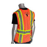 A mannequin showcases the PIP Orange Mesh D-Ring Access Hi-Vis Vest 302-0600D-OR, featuring a vibrant orange color with neon yellow and gray reflective tape. The back view highlights its high visibility design, enhancing safety. A plain black shirt worn underneath completes the ensemble by complementing the vest.