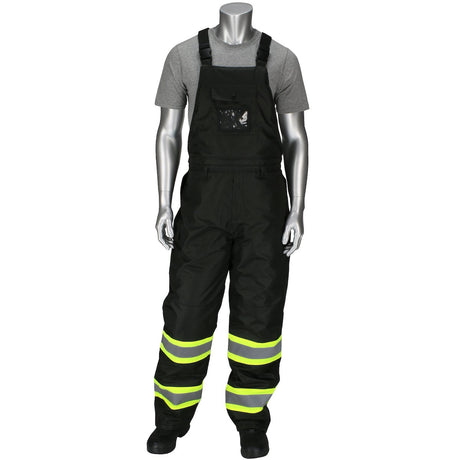 A mannequin is dressed in the PIP Ripstop Insulated Two Tone Bib Overalls 318-1780 by PIP - Protective Industrial Products, featuring a gray t-shirt and black overalls with Hi-Vis Yellow reflective stripes on the legs. These overalls, classified as Class 3 apparel, come with adjustable shoulder straps and a chest pocket, all perfectly posed against a plain white background.