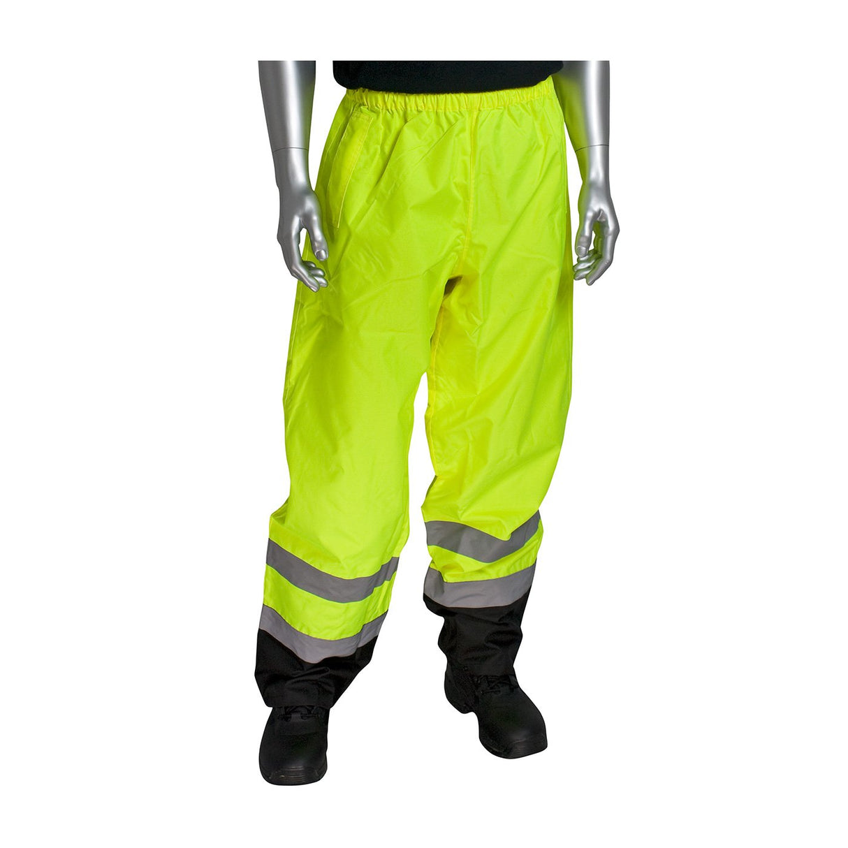 Displayed on a mannequin are the PIP Class E Value Black Trim Over Pant 318-1757 by Protective Industrial Products. These safety trousers, crafted from waterproof polyester, boast a vibrant yellow color and feature reflective silver stripes near the bottom. They are designed with an elastic waistband and are paired with black shoes.