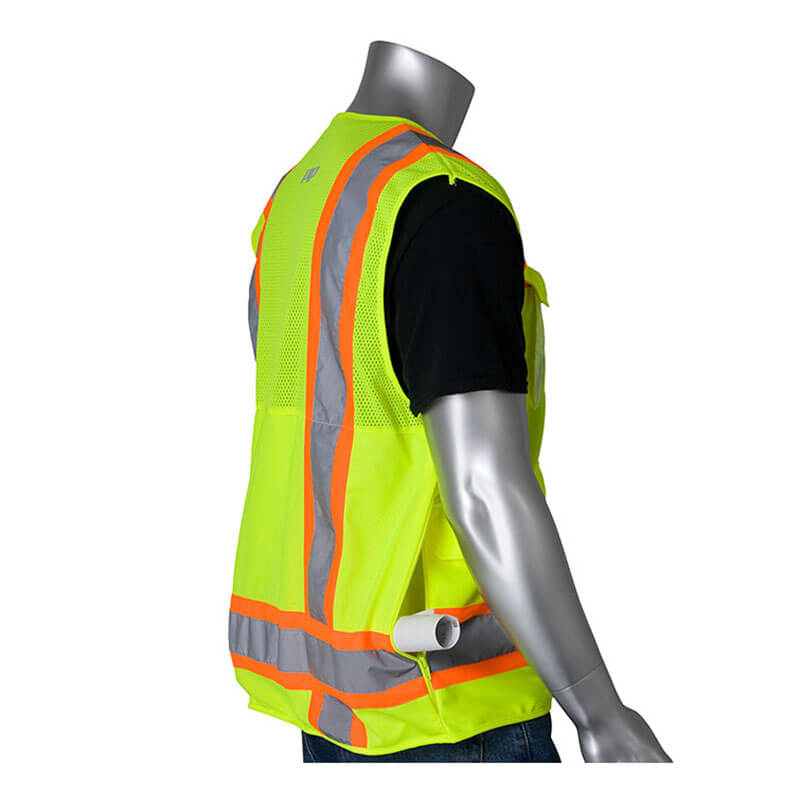 A silver mannequin, viewed from the side, wears a PIP Hi-Vis Yellow Pocket Surveyors Tech Vest 302-0700LY with orange and gray reflective stripes (ANSI/ISEA 107 Class 2), over a black shirt, with rolled white paper in a side pocket.