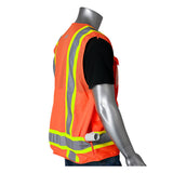 A mannequin models the PIP Hi-Vis Orange Pocket Surveyors Tech Vest 302-0700OR, featuring gray reflective stripes and pockets, shown from the side over a black shirt—ideal safety gear for on-site professionals.