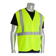 A silver mannequin wears a black shirt and a PIP Class 2 Solid Fabric Reflective Safety Vest 302-WCENGLY in bright yellow with gray reflective stripes over the shoulders and waist. The background is plain white.