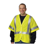 A smiling person wears a PIP ANSI Type R Class 3 AR/FR Mesh Vest 305-3100 over a dark long-sleeve shirt, standing against a white background.