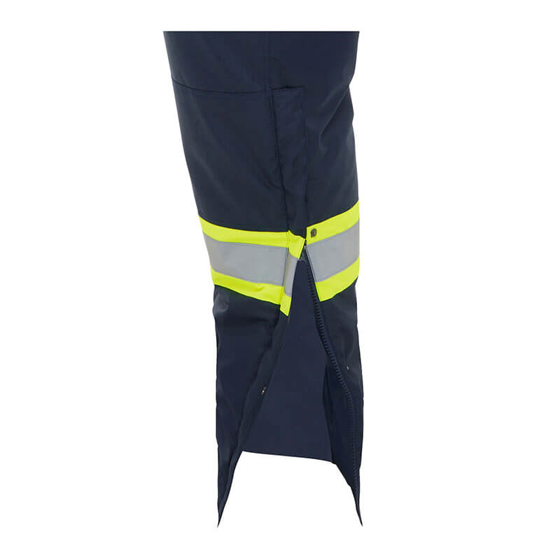 Close-up of the PIP Bisley Navy Extreme Cold Bib Overall 318M6459T showing a pant leg with yellow and silver reflective stripes and a partially open side zipper at the bottom.