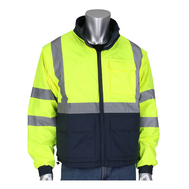 A mannequin showcases the PIP Black Label 4-in-1 Reversible Windbreaker by Protective Industrial Products, featuring Class R3 visibility with fluorescent yellow and dark blue hues. The windbreaker flaunts reflective gray stripes on the sleeves and chest, complemented by a zippered front and dark blue pockets.