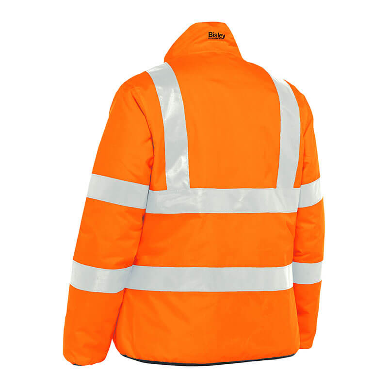 This vibrant high-visibility safety jacket, known as the PIP Bisley ANSI Type R Class 3 Women's Reversible Puffer Jacket, is accented with reflective silver stripes on the torso and arms. The brand "PIP - Protective Industrial Products" is visible near the collar from behind. It is designed to enhance visibility in low-light conditions.