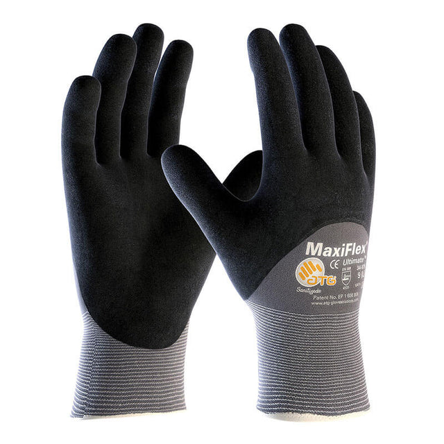 A pair of PIP ATG MaxiFlex Ultimate Micro-Foam 3/4 Coated Palm Nitrile Gloves 34-875 (black/gray) is shown upright with palms forward, displaying logos and text on the cuffs.