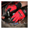 Wearing MCR Safety Ninja Red Nylon Spandex Breathable Nitrile Gloves N96970, a person uses a tool to tighten or loosen a bolt on a large, greasy metal gear.